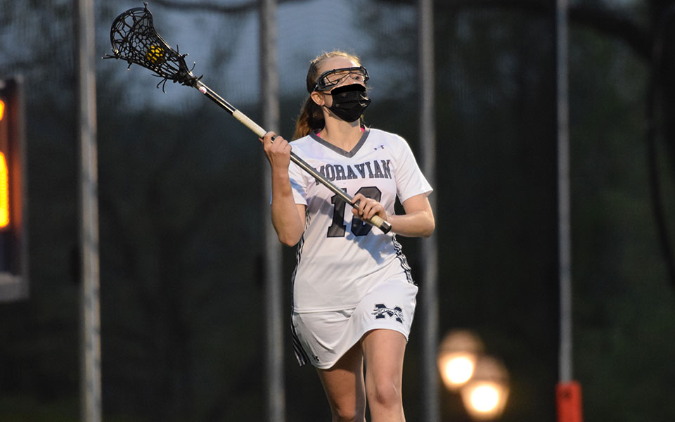 Danielle Sullivan '21 looks to pass from behind the net on John Makuvek Field during the first half of a Landmark Conference Semifinal match versus Elizabethtown College on April 24, 2021.