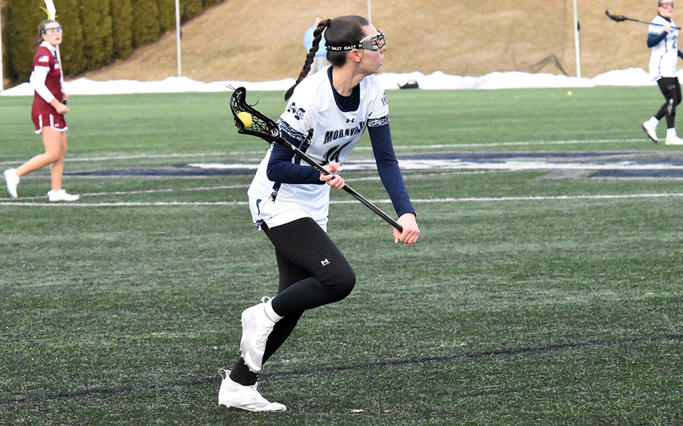 Freshman midfielder Ella Steirer brings the ball upfield versus Muhlenberg College on John Makuvek Field this season. Photo by Anika Buzzy '25