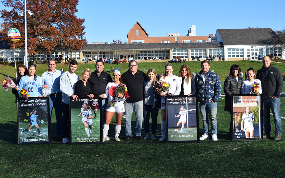 Seniors Julina Caranci, Jamie Daly, Taylor Irr and Paige Weiss with their families on Senior Day prior to playing Goucher College on John Makuvek Field.