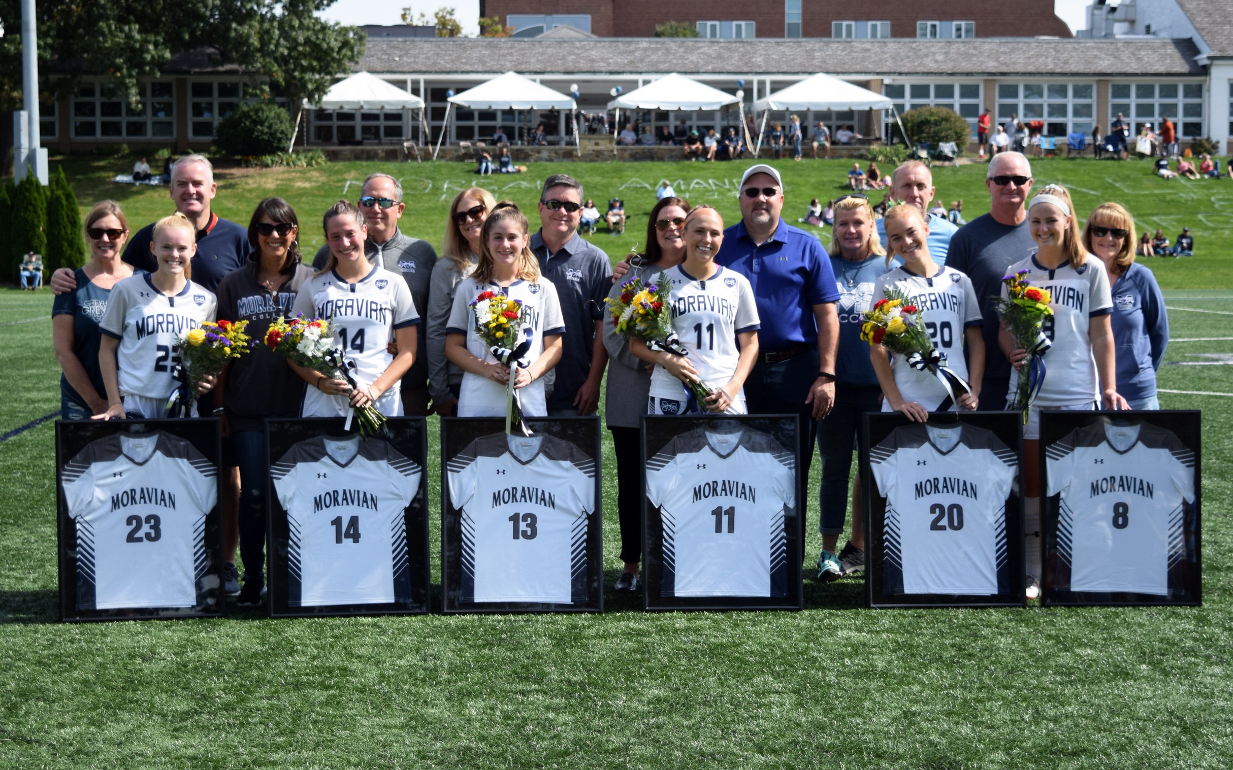 The six members of the Moravian Women's Soccer Class of 2022 and their parents prior to the Senior Day match versus Goucher College on John Makuvek Field.