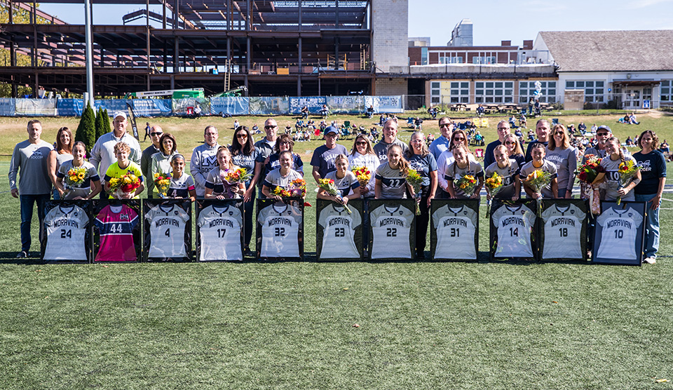 The 2024 Moravian University women's soccer seniors and their families on Senior Day. Photo by Cosmic Fox Media / Matthew Levine '11