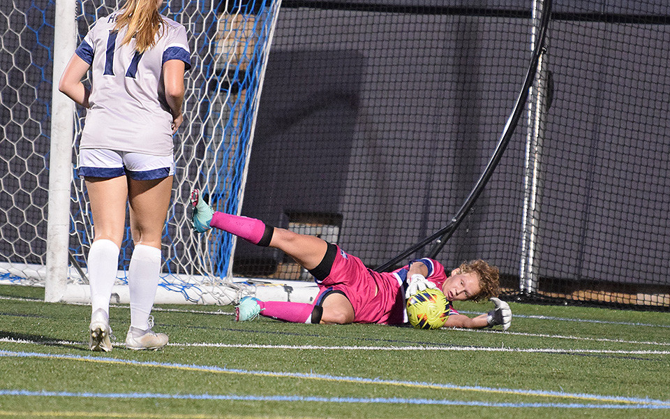 Graduate student goalie Riley Spingler dives to make a save during the first half versus No. 5 Misericordia University on John Makuvek Field. Photo by Emma Kressler '27