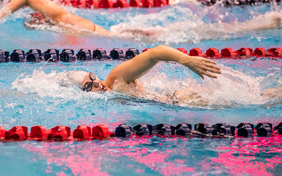 Sophomore Catie Lovett swims in the 400 yard freestyle relay in a double dual meet with Goucher College and Susquehanna University at Liberty High School's Memorial Pool. Photo by Cosmic Fox Media / Matthew Levine '11