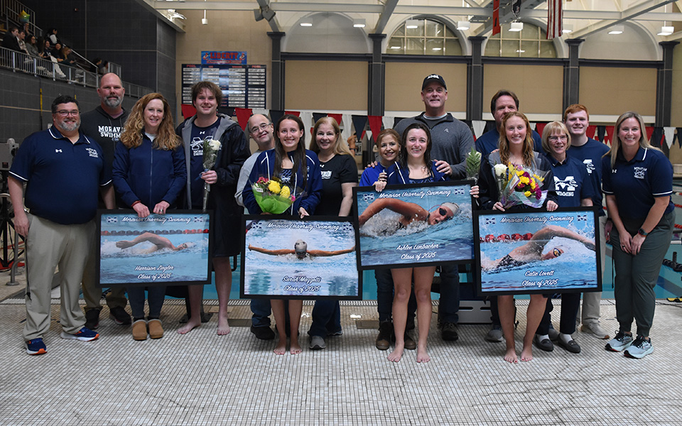 Seniors Harrison Ziegler, Sarah Mazzetti, Ashley Limbacher and Catie Lovett with their families and coaches on Senior Day at Liberty High School's Memorial Pool. Photo by Christine Fox