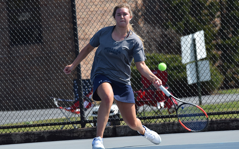 Sophomore Emma Angle returns a shot during singles action versus The Catholic University of America at Hoffman Courts.