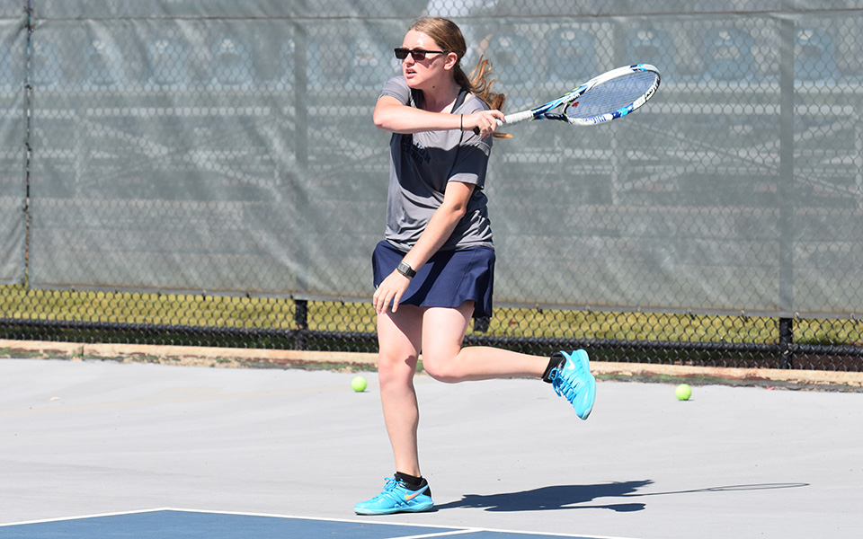 Destiny George returns a shot in doubles action versus Misericordia University at Hoffman Courts.