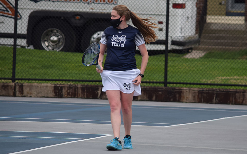 Destiny George '21 gets set to serve during her singles match versus Juniata College at Hoffman Courts.