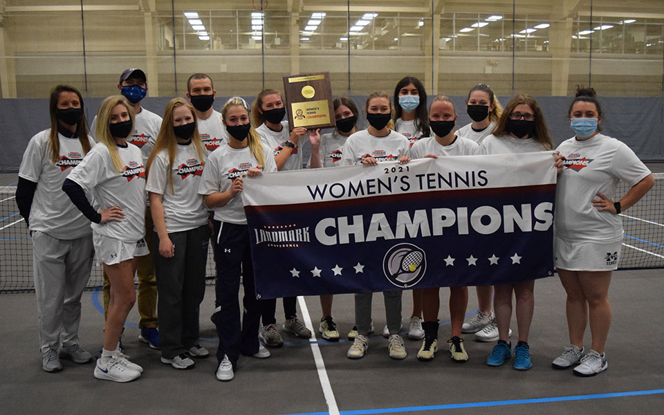 The Greyhounds hold the banner and championship plaque after defeating The University of Scranton, 5-4, in the 2021 Landmark Conference Championship match that took over nine hours to play in Timothy Breidegam Fieldhouse on May 9, 2021.