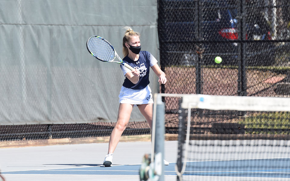 Brooke Adams '21 returns a shot in singles action in a match versus Immaculata University at Hoffman Courts on March 21, 2021.