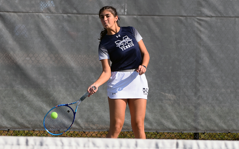 Junior Cristina Merone returns a shot on Hoffman Tennis Courts.