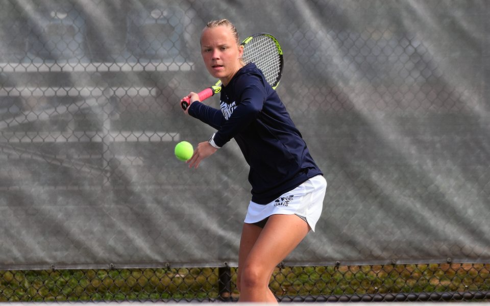 Junior Maddie Figiel returns a shot in a non-conference match versus Cedar Crest College during the fall portion of the 2021-22 season on Hoffman Courts.