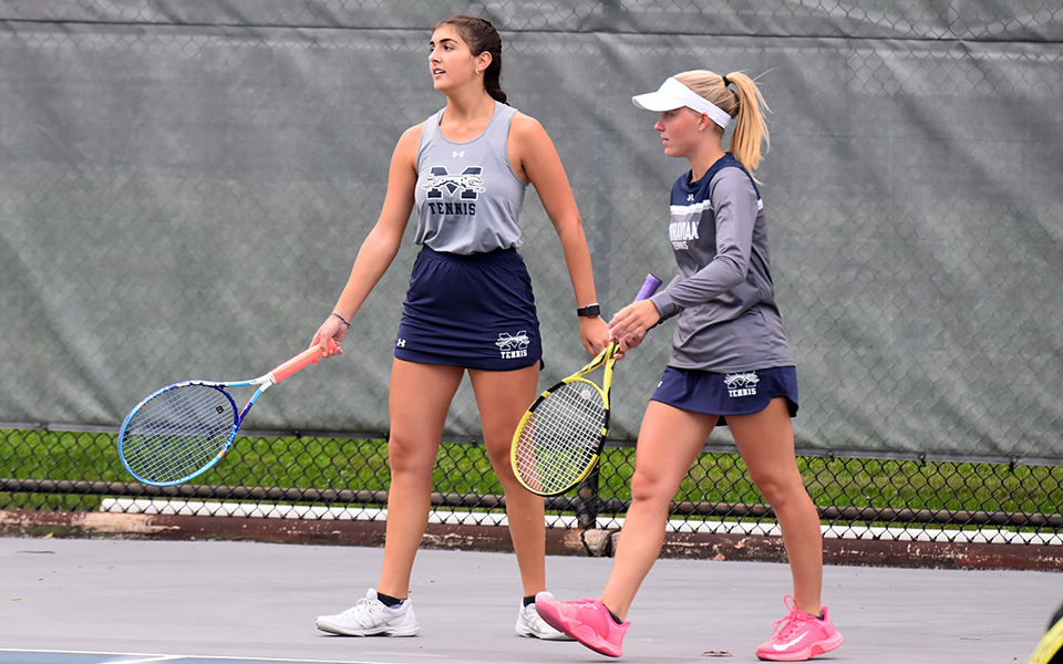 Seniors Maddie Figiel and Cristina Merone after a doubles point in a match versus Muhlenberg College at Hoffman Courts last fall.