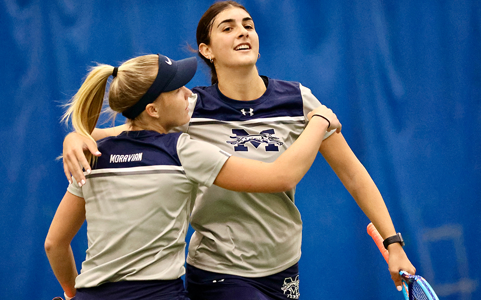Seniors Maddie Figiel and Cristina Merone celebrate their win at second doubles in the 2023 Landmark Conference Championship match at Drew University as the duo became the first in program history to reach 20 doubles victories in a single season. Photo by Entrophy Sports Photography/Robert Koch