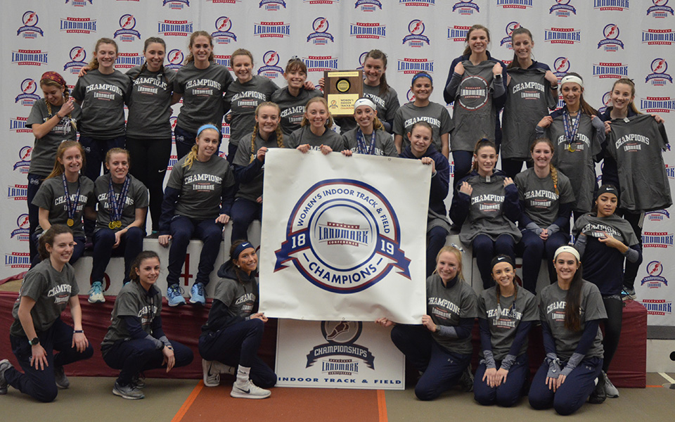 The women's track & field team on the podium after winning the 2019 Landmark Conference Indoor Championship at Susquehanna University.