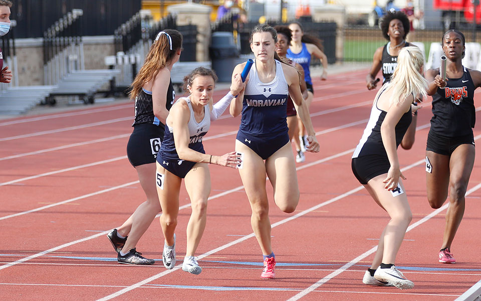 Rachel Byrne '23 hands off to Camaryn Wheeler '21 during the 4x400-meter relay at the 2021 All-Atlantic Region Outdoor Championships at St. John Fisher College. Photo courtesy of Wyatt Eaton, Elizabethtown College Athletic Communications.