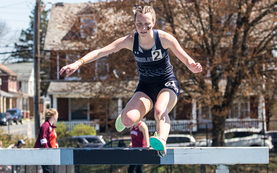 Freshman Rachael Goodman clears a hurdle in the 3,000-meter steeplechase at the Greyhound Invitational. Photo by Cosmic Fox Media / Matthew Levine '11