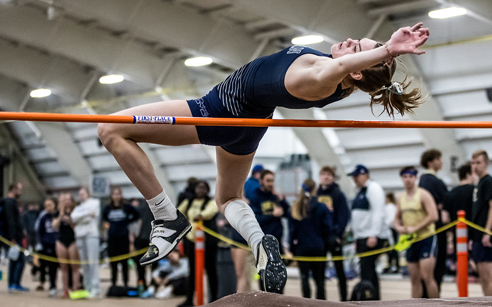 Senior Lexi Groff clears the high jump bar in the Moravian Indoor Meet at Lehigh University's Rauch Field House this season. Photo by Cosmic Fox Media / Matthew Levine '11