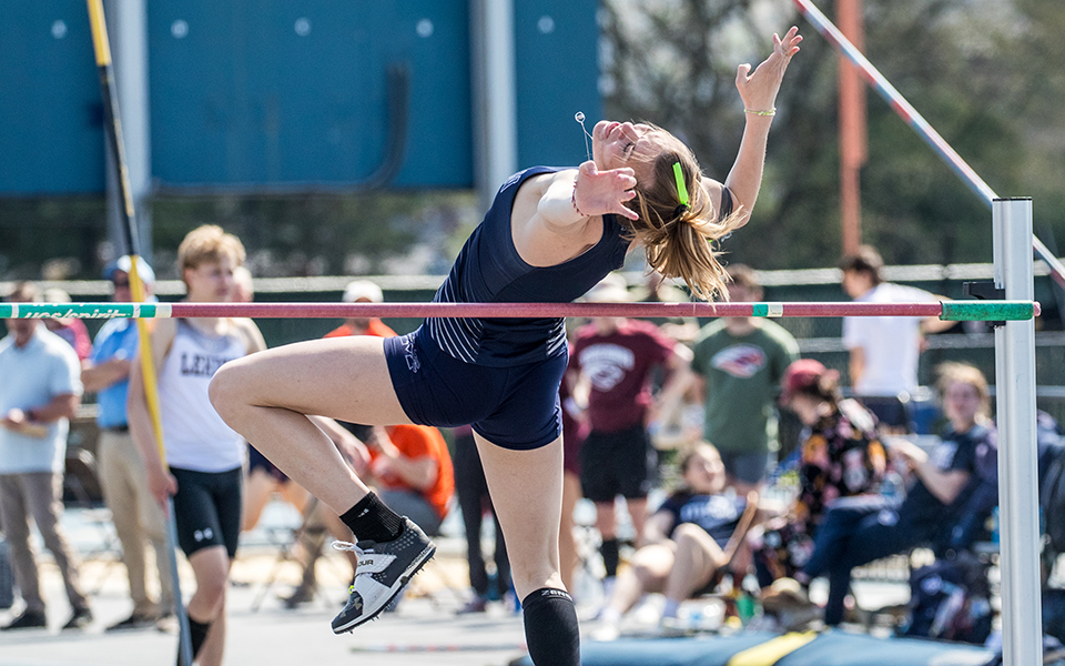 Senior Lexi Groff clears the bar during the high jump in the 2024 Coach Pollard Invitational at Timothy Breidegam Track. Photo by Cosmic Fox Media / Matthew Levine '11