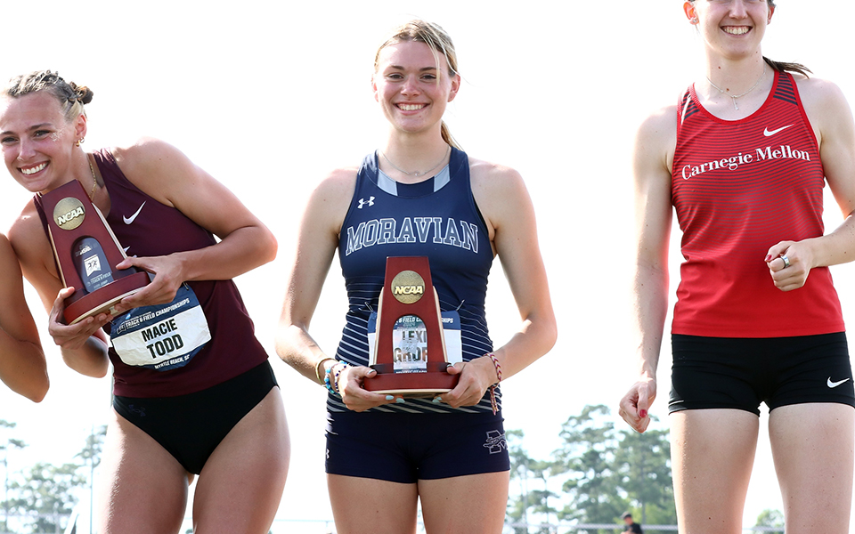 Senior Lexi Groff on the awards podium with her fifth place trophy after earning All-America honors at the 2024 NCAA Division III Outdoor National Championships in Myrtle Beach. Photo by d3photography.com