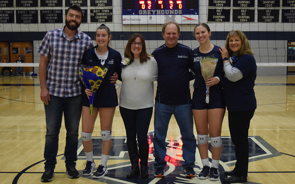 Seniors Alexis Szaro and Victoria Kauffman with their parents on Senior Night before the start of the match versus Penn State Berks in Johnston Hall.