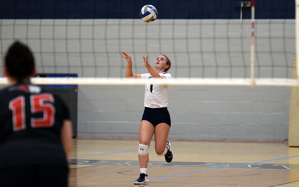 Emily Szy heads up for a jump serve in the third set versus Bryn Athyn College in Johnston Hall. Photo by Mairi West '23.