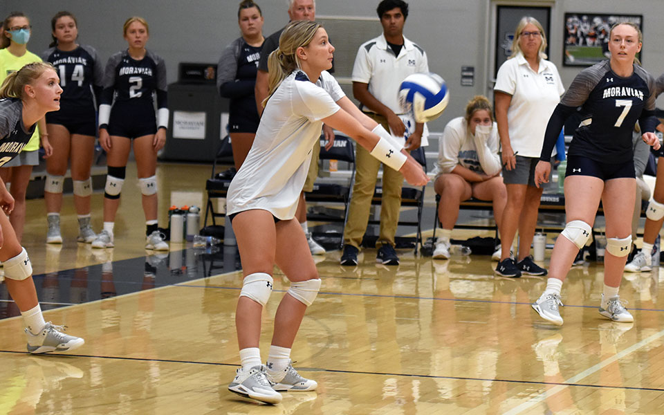 Senior libero Gabby Mancini digs a ball versus Baruch (N.Y.) College in Johnston Hall during the Greyhound Premiere Invitational. Photo by Mairi West '23