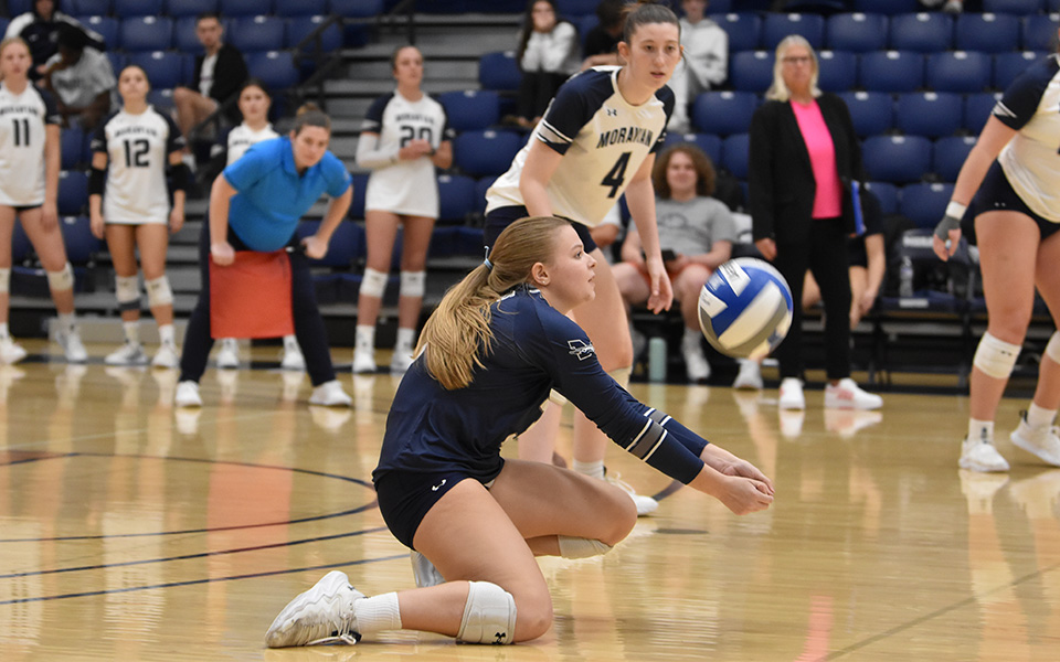 Sophomore libero Sam Love digs a ball in the fourth set versus The Catholic University of America in Johnston Hall. Photo by Abby Smith '27