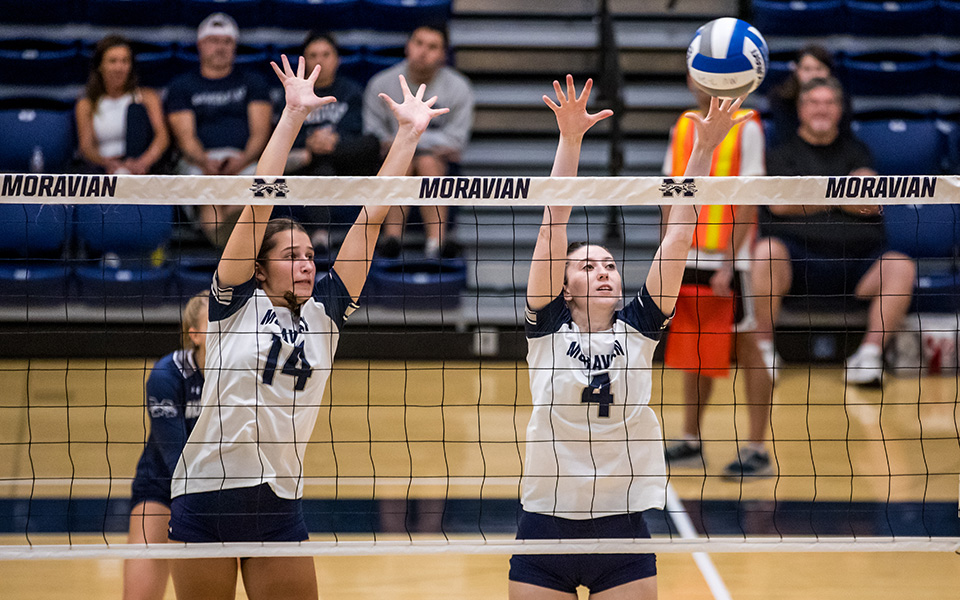 Freshman middle blocker Kate McBrierty and sophomore outside hitter Gabby Reigner go up for a block versus Alvernia University in the Greyhound Premiere Invitational in Johnston Hall this season. Photo by Cosmic Fox Media / Matthew Levine '11