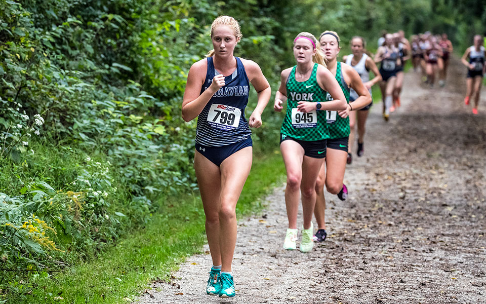 Catie Lovett races down the back path at Bicentennial Park during the Moravian Invitational earlier this season. Photo by Cosmic Fox Media / Matthew Levine '11.