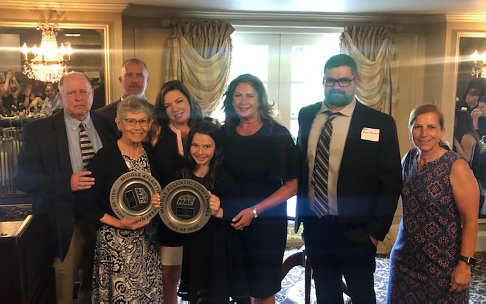 Coach Scot Dapp, Coach Jeff Pukszyn; Patricia (Sean’s mother), Madeline (Sean’s wife); Maggie (Sean’s daughter); Kim (Sean’s sister); Ryan (Sean’s brother); Coach Mary Beth Spirk at MAC Hall of Fame presentation for Sean Keville '96