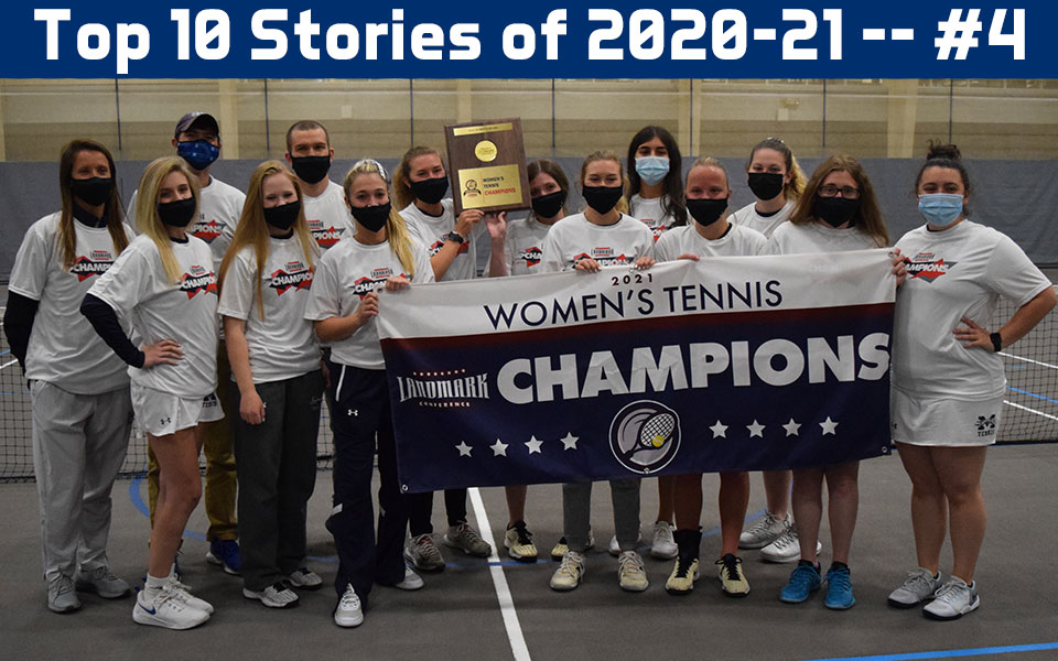 Women's tennis team with landmark conference championship plaque and banner