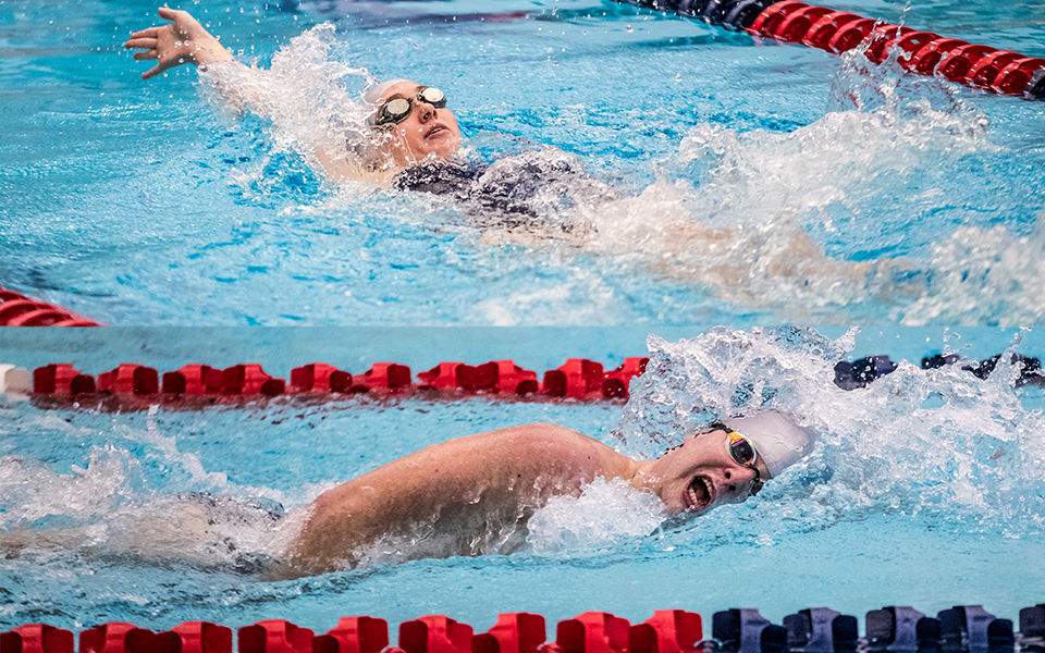 Juniors Catie Lovett and Harrison Ziegler swim in a double dual meet with Goucher College and Susquehanna University at Liberty High School's Memorial Pool during the 2022-23 season. Photos by Cosmic Fox Media / Matthew Levine '11