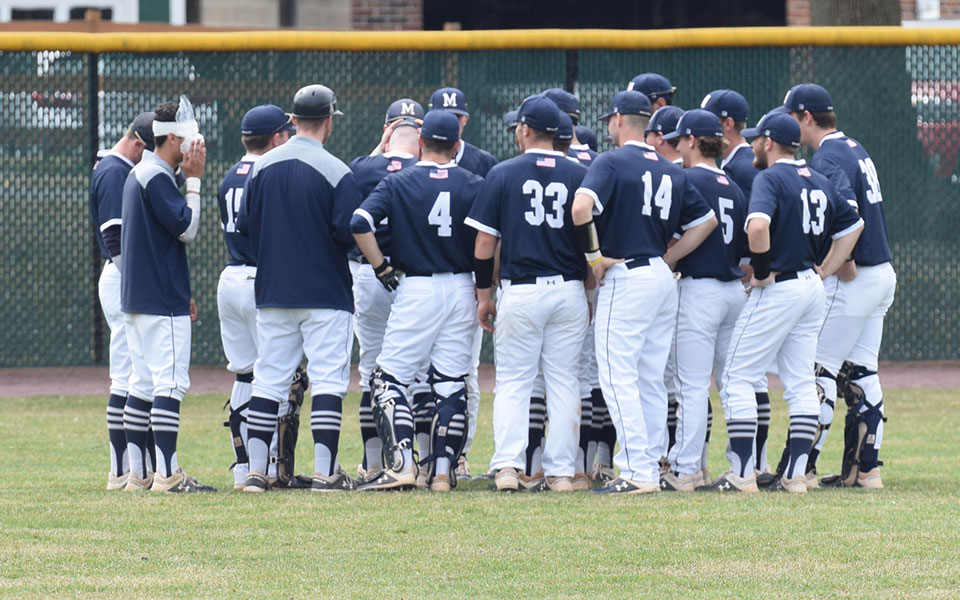 The Greyhounds talk in the outfield before a game against Susquehanna University at Gillespie Field during the 2019 season.