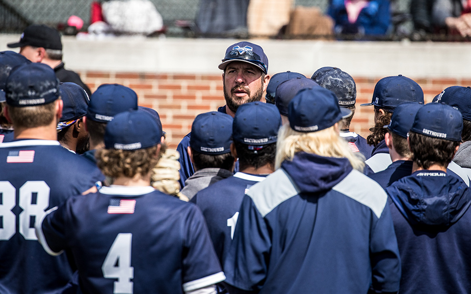 Head Coach Douglas Coe talks with the Greyhounds before the start of a Landmark Conference doubleheader versus Susquehanna University at Gillespie Field during the 2023 season. Photo by Cosmic Fox Media / Matthew Levine '11