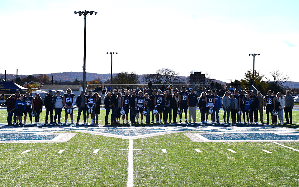 The 2023 Moravian football seniors with their families on Senior Day at Rocco Calvo Field prior to playing Wilkes University. Photo by Ryan Fleming