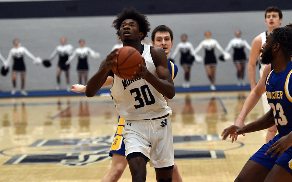 Freshman forward Marquis Ratcliff drives down the lane in the first half of a contest versus Goucher College in Johnston Hall. Photo by Aidan Evans-Gartley '23