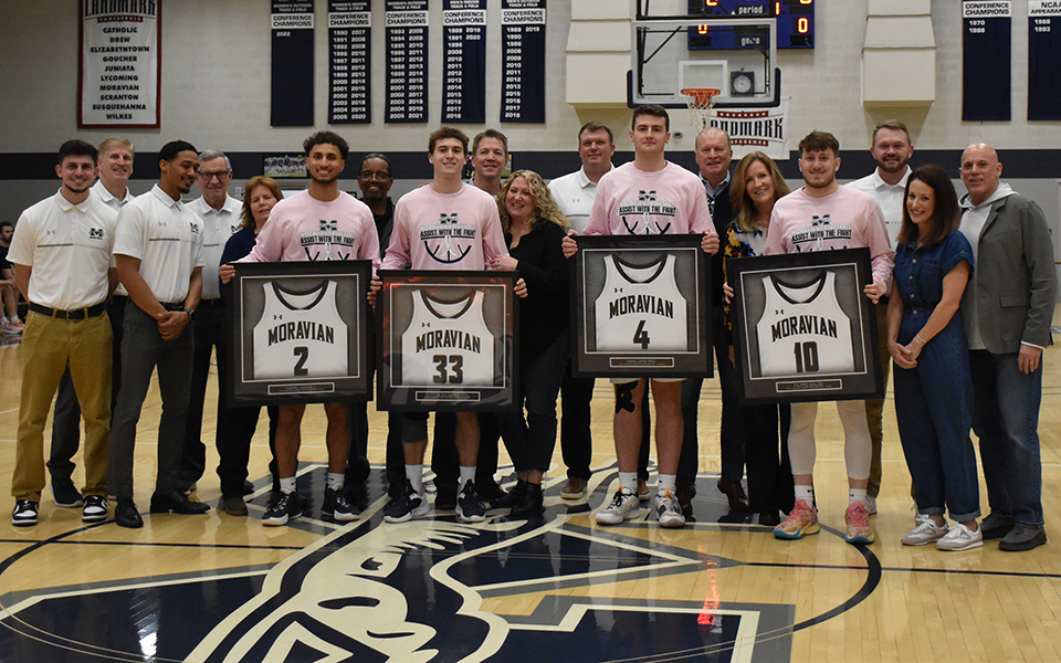 Seniors Mark Howell, Alex Dietz, Mike DiPietro and Filippo Baldo with the parents and coaches on Senior Day in Johnston Hall. Photo by Grace Nelson '26