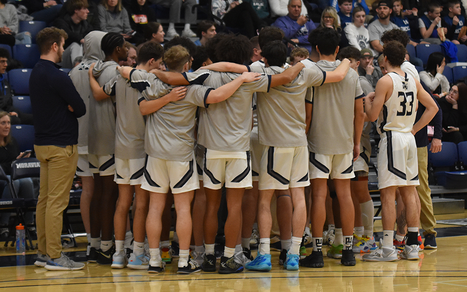 The Hounds huddle before their final home game versus Susquehanna University in Johnston Hall in February 2023. Photo by Casey Frank '24