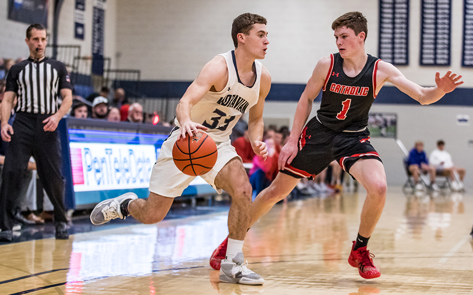 Senior guard Alex Dietz makes a move towards the basket in a game versus The Catholic University of America in Johnston Hall during the 2022-23 season. Photo by Cosmic Fox Media / Matthew Levine '11