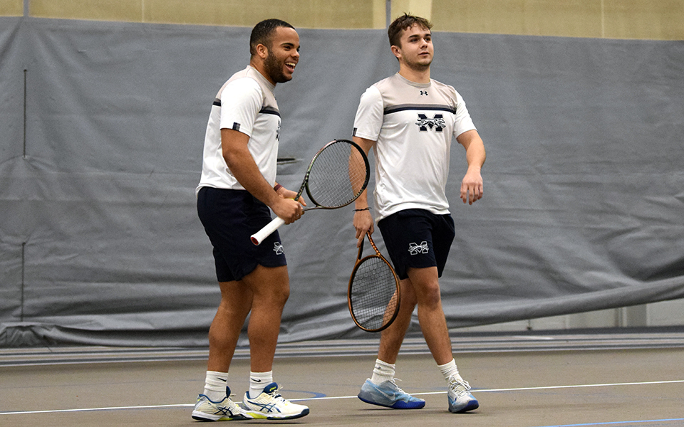 Juniors Ronny Pimentel Ferrer and Wyatt Marshall celebrate a point in their doubles match versus FDU-Florham in Timothy Breidegam Fieldhouse. Photo by graduate student Riley Spingler