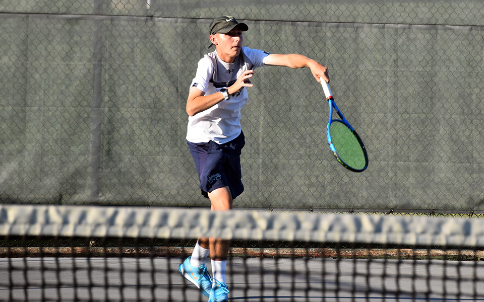 Freshman Gavin Labbadia serves during singles action versus Muhlenberg College at Hoffman Courts in the 2023-24 season opener. Photo by Christine Fox