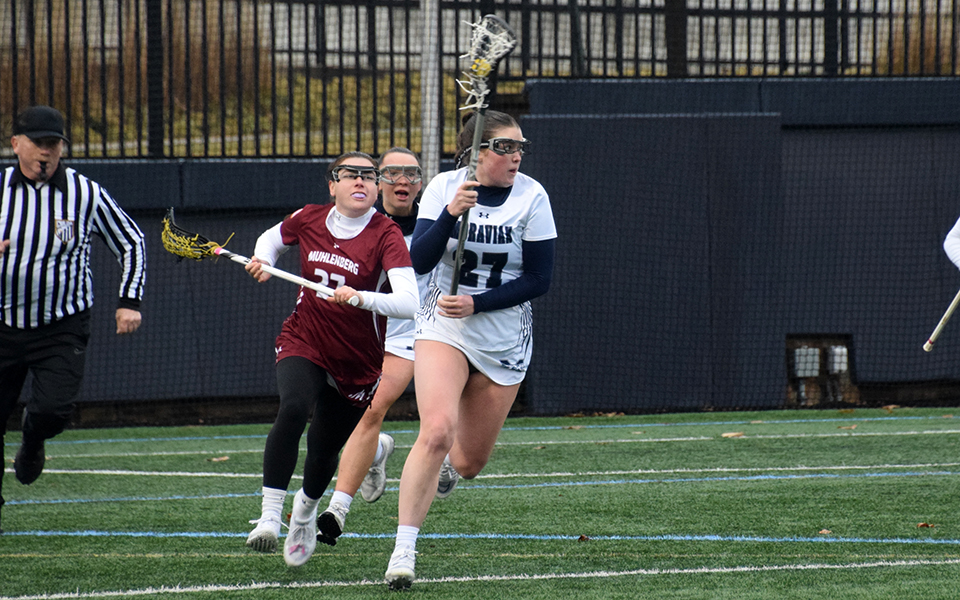 Junior defender Keara Reilly heads up field after scooping up a ground ball in the 2023 season opener versus Muhlenberg College on John Makuvek Field. Photo by Grace Nelson '26