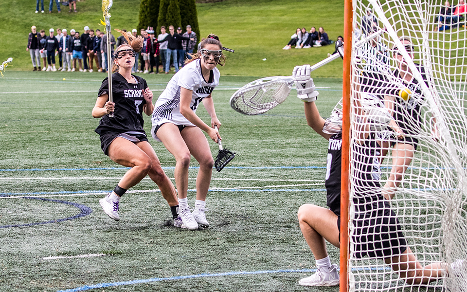Sophomore attack Madi Dippel fires a shot into the net during the third quarter of the Landmark Conference Semifinal match with The University of Scranton on John Makuvek Field. Photo by Cosmic Fox Media / Matthew Levine '11