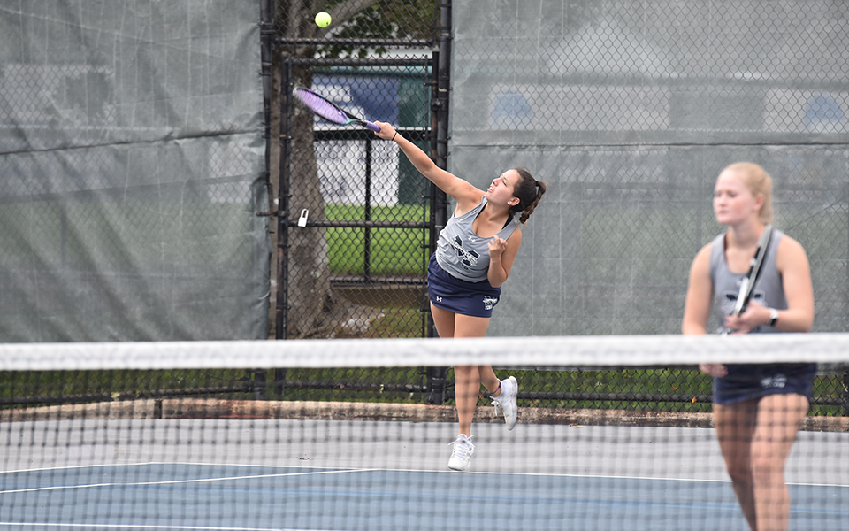 Freshman Izzy Szmodis servers during doubles action versus rival Muhlenberg College at Hoffman Courts.