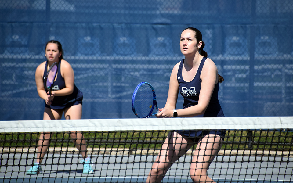 Senior Mara Stapleton and sophomore Izzy Szmodis wait for a serve in doubles action versus Penn State Abington at Hoffman Courts.