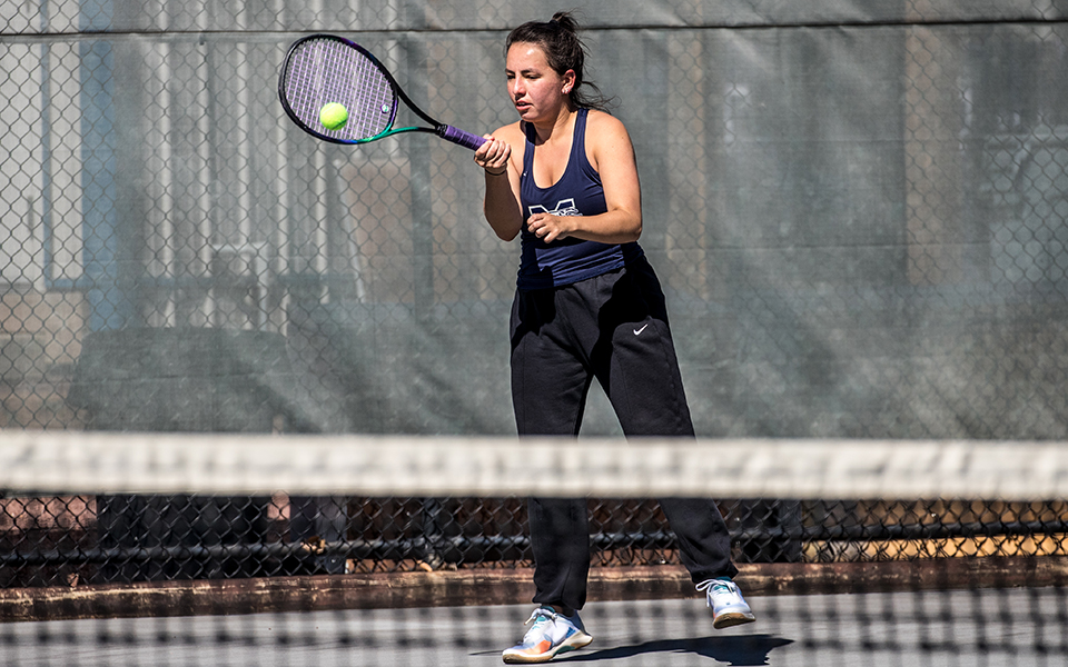 Sophomore Izzy Szmodis returns a shot in doubles action in a match versus Goucher College at Hoffman Courts during the 2022-23 season. Photo by Cosmic Fox Media / Matthew Levine '11